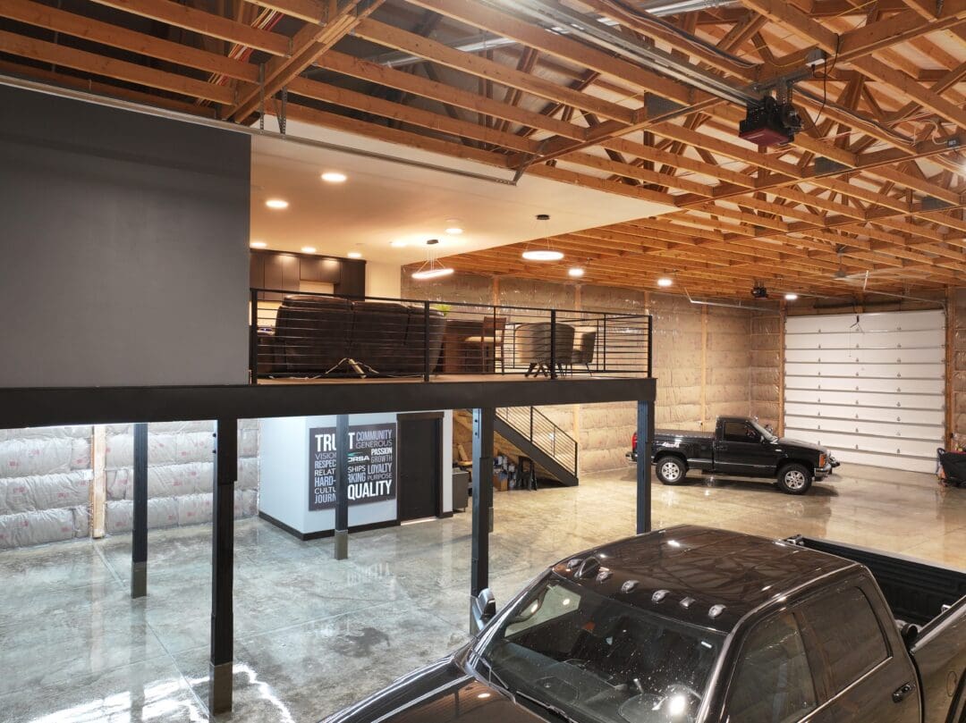 A view of a pole barn garage with a loft area above the parking