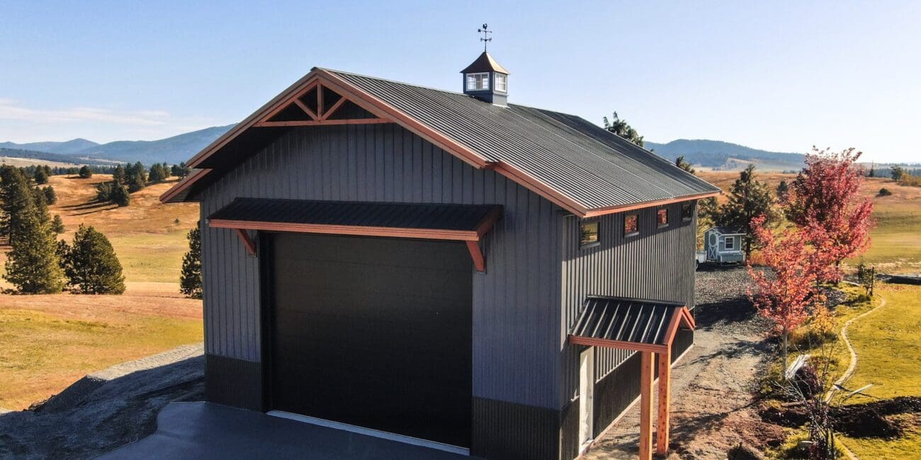 stylish charcoal gray building with copper styled steel roof in the fall landscape