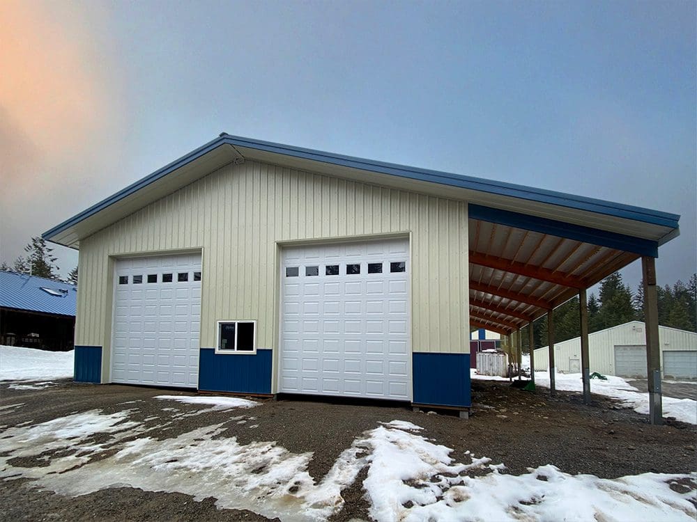 ivory garage with blue trim and white over-head garage doors
