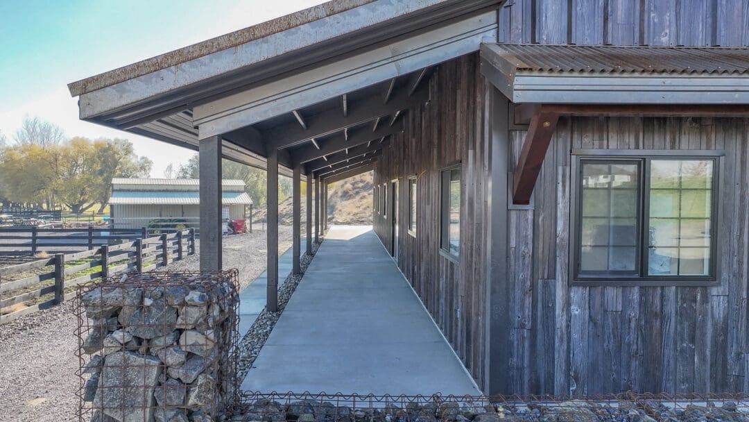 A small lean-to used as a covered porch on this barndominium