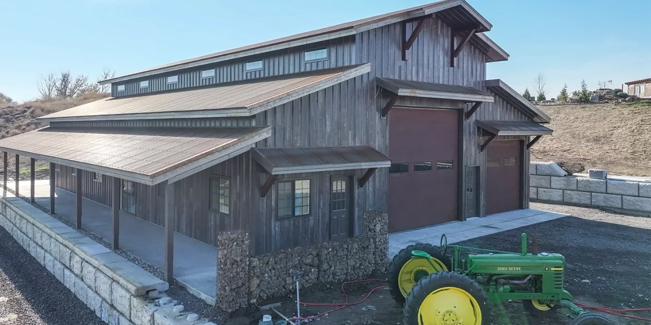 A pole barn with wood look metal siding and pot frame construction