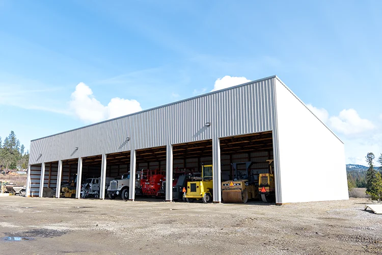 A farm equipment storage building housing mutiple large farm vehicles
