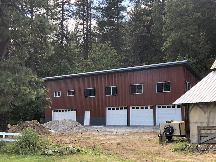 A barndominium design that has the living space in a loft above the garage and workshop