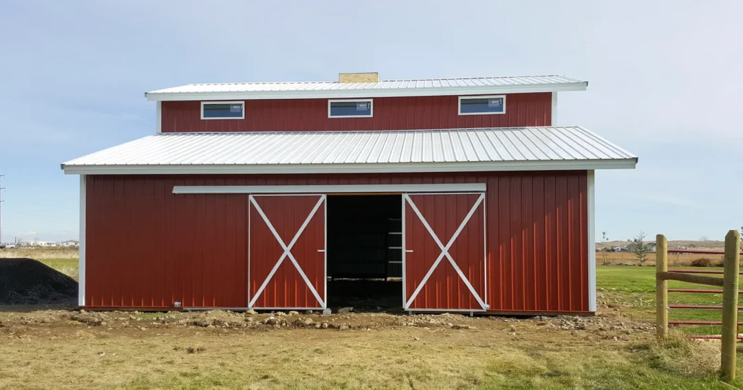 A red barn with its sliding barn doors open