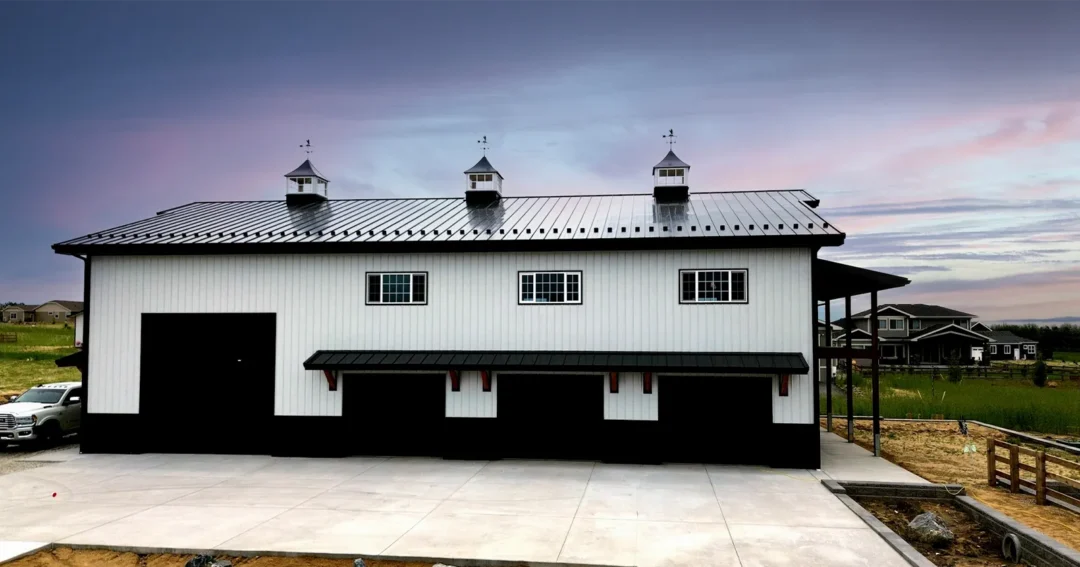 A barndominium with a beautiful sunset purchases as the result of a complete barndominium planning checklist