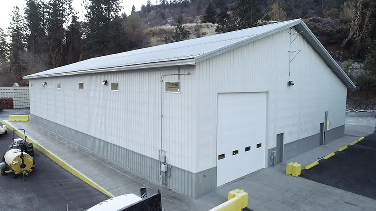 A mid sized white farm equipment storage building