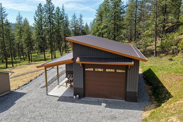 A midsized attractive pole barn garage with wood look accents and a custom garage door