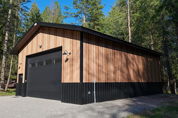 A pole barn detached garage in two tone black and wood look
