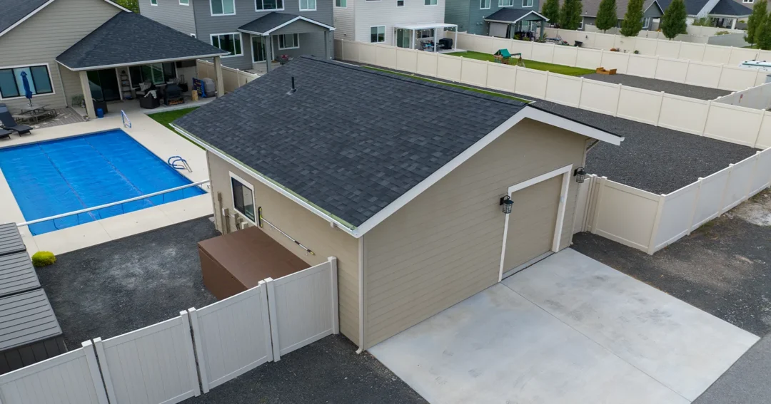 A pole barn garage. Tan in color with white trim