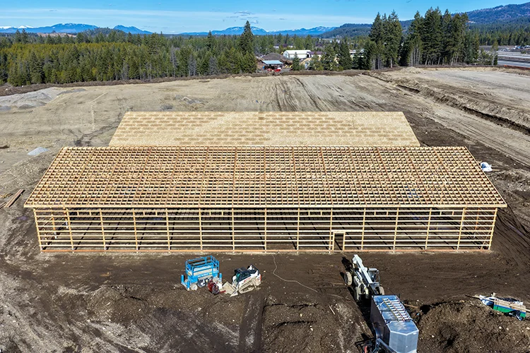 An image of an incomplete post frame building, showing the construction method