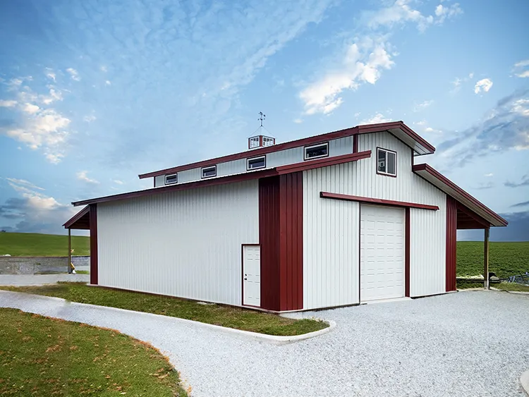 A white and red ventilated pole barn