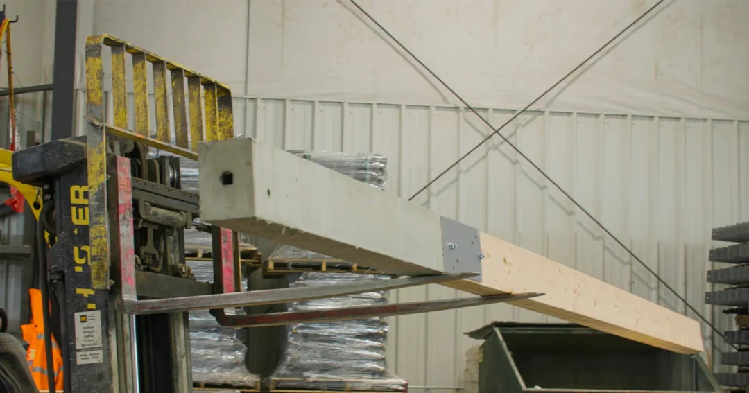 A forklift is holding a large perma-column post