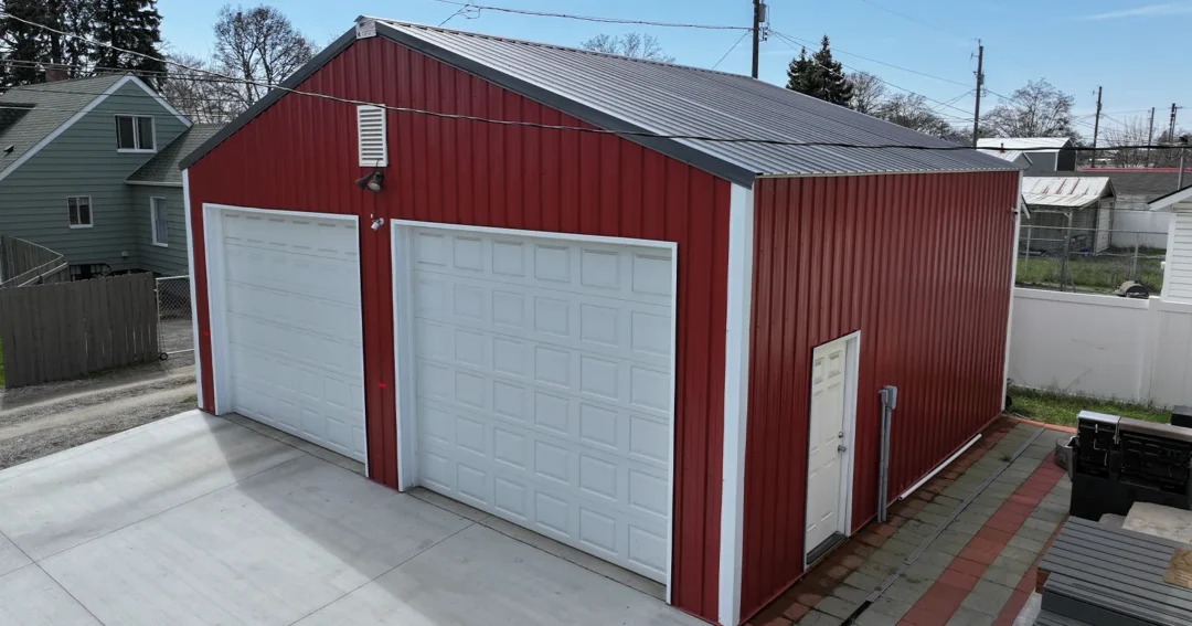 Pole barn construction loans allowed this red shop with white doors to be built