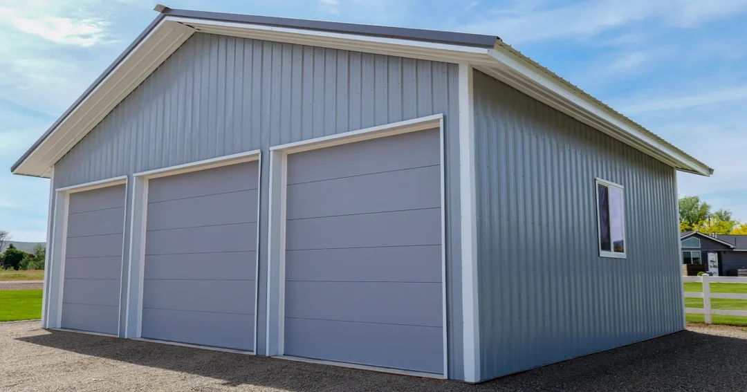A pole barn that was purchased with pole barn financing. Grey in color with 3 doors
