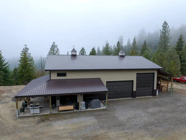 A 40x60x16 metal workshop with a lean-to in Newman Lake, Washington, a 40 x 60 metal building with covered space added