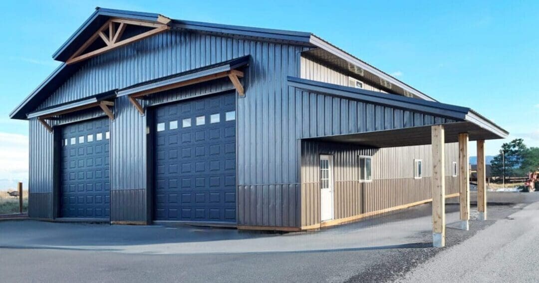 A black metal building with a lean-to in Kalispell, Montana, built larger than a standard 30x50 steel building