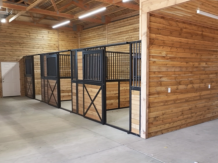 Horse stalls inside a custom post-frame barn, the interior work horse barn builders should show you