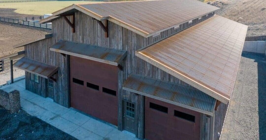 Corrugated steel roof on a pole barn building, showing the metal roof surface where ridge caps seal the peak