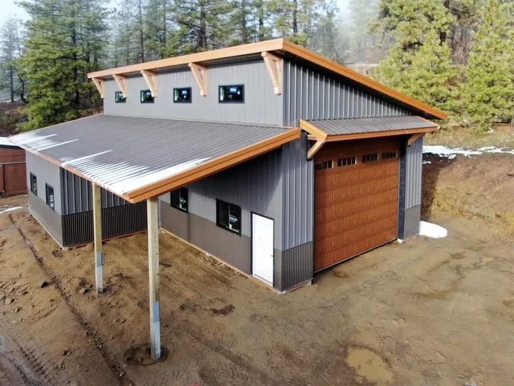 A monoslope shop with an attached lean-to, single-slope roof sloping from the tall front wall to the back