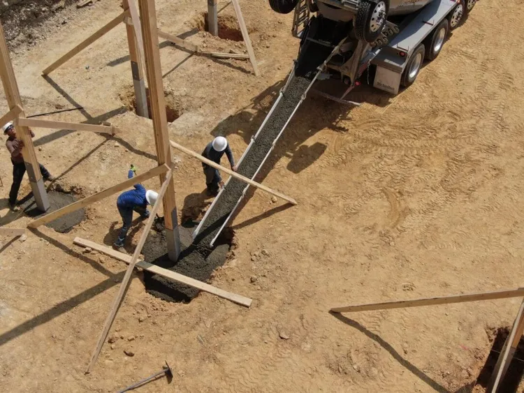 Pole barn framing with trusses spanning the width, giving a 40x100 pole barn a clear-span interior