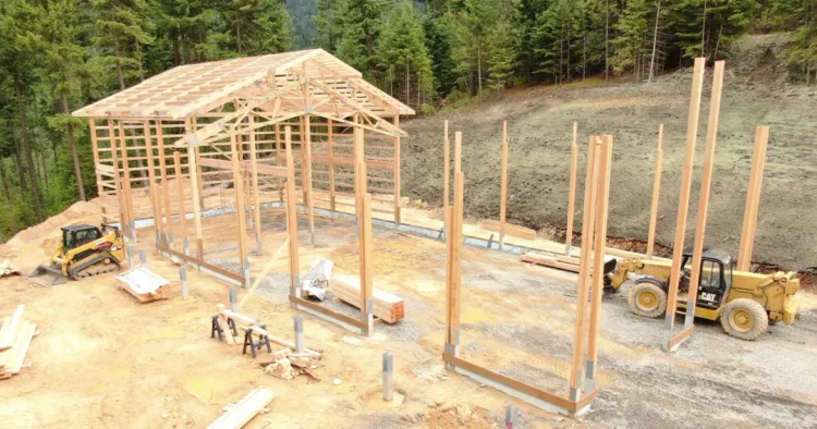 Site prep for a pole barn with heavy equipment moving soil, work a pole barn builder should scope up front