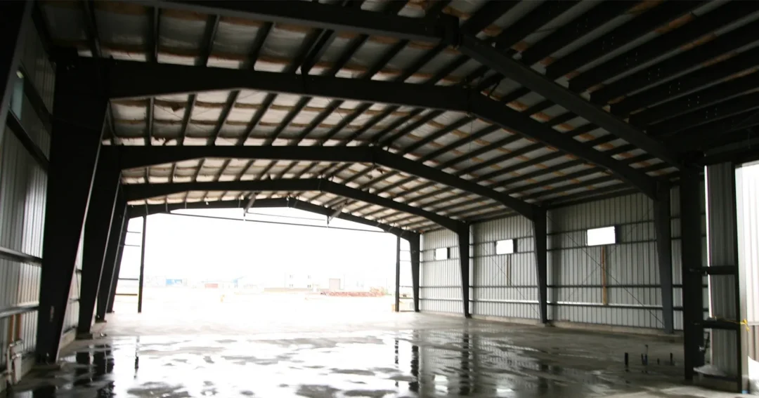 Pole barn framing with trusses spanning the building, showing how metal pole barn trusses create clear span