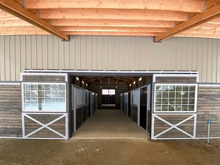 Small sliding barn doors leading into a stable, sized as exterior barn doors for daily animal access