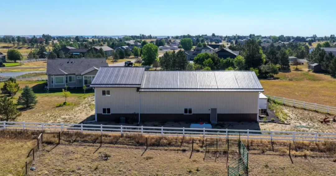 A Parker, CO post-frame shop with a Burnished Slate steel gable roof, the kind of building where a 4/12 roof pitch is common
