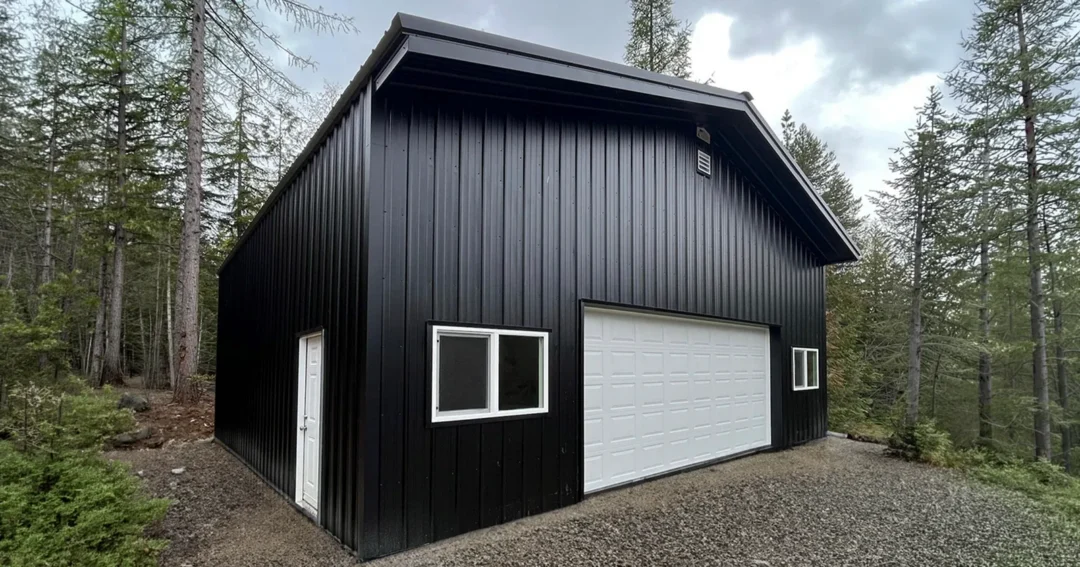 A Leavenworth, WA shop with a Matte Black roof and trim over Rural Red siding, a black metal building accent pairing