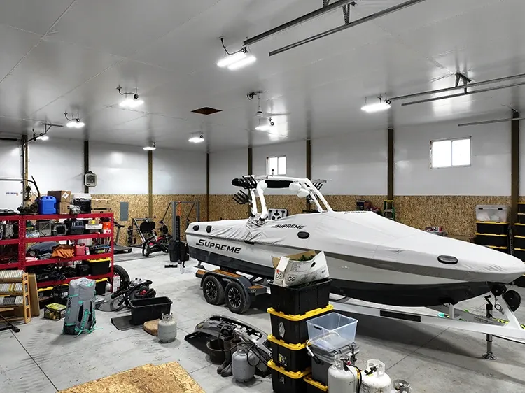 Pole barn interior with room for a boat and tools, the working space a boat storage building should allow for