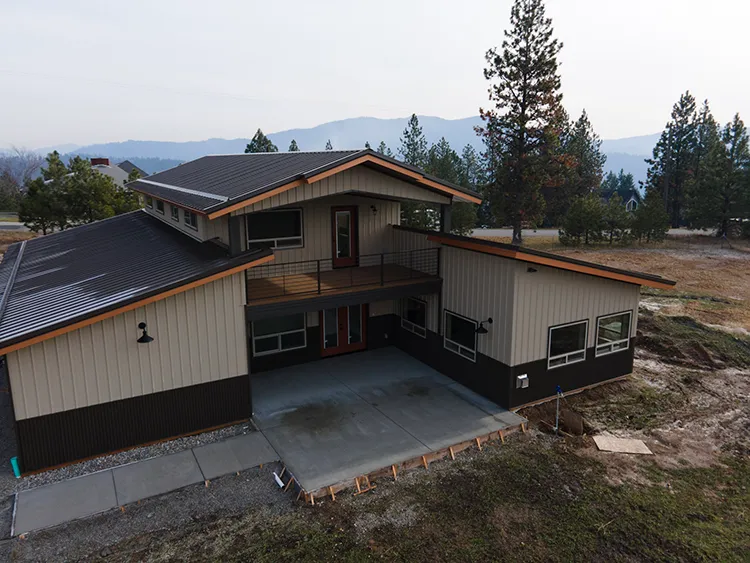 Custom barndominium layout with the living space in the center and the workshop wrapped around it