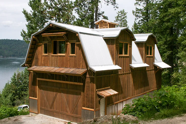 Gambrel pole barn on Lake Coeur d'Alene with wood-look steel siding and a gambrel truss roofline