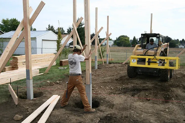 Crew setting Perma-Column posts for a pole barn, a foundation that prevents pole barn post rot