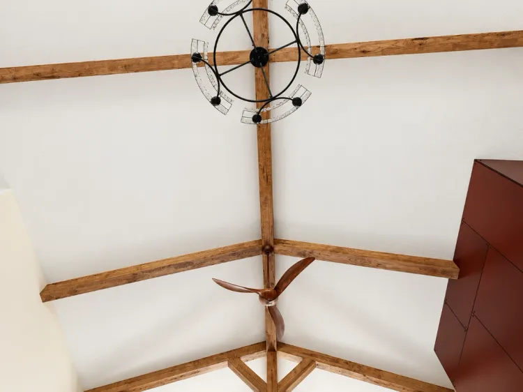 Vaulted ceiling with a rustic chandelier and ceiling fan in a luxury barndominium great room